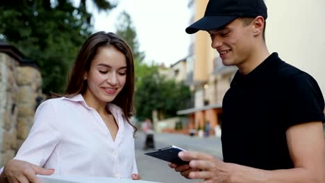 Mensajero-entrega-de-Pizza.-Mujer-que-recibe-el-paquete-del-alimento-cerca-de-casa