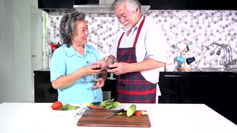 Senior-couple-preparing-food-in-kitchen.