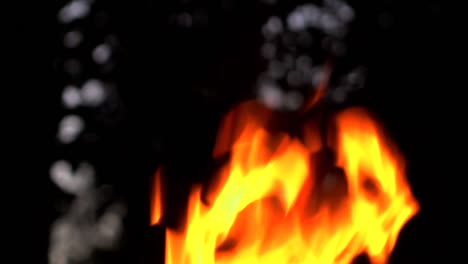 Fire-burns-at-night-against-background-of-dark-sky.