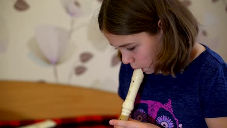 Girl-Practicing-Playing-Flute-at-Home