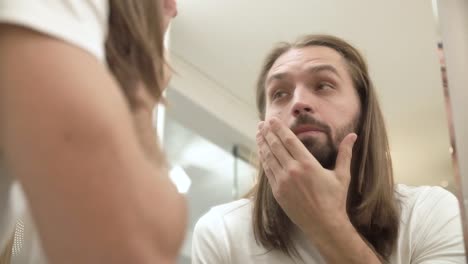 Sleepy-Man-Looking-In-Mirror-At-Bathroom