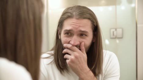 Sleepy-Man-Looking-In-Mirror-At-Bathroom