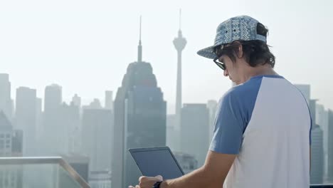 Freelancer-using-laptop-on-modern-city-background.