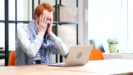 Beard-Man-Upset-by-Loss-while-Working-on-Laptop