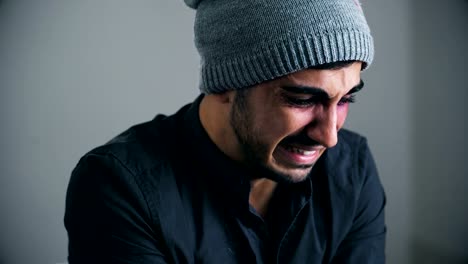 portrait-of-Young-man-beaten-and-wounded-cries-looking-at-the-camera