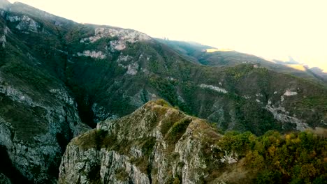 A-small-chapel-on-the-mountain-edge-against-at-the-morning.-Aerial-shot