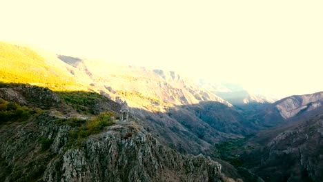 A-small-chapel-on-the-mountain-edge-against-at-the-morning.-Aerial-shot