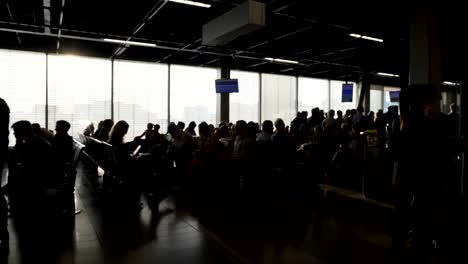 Passengers-sitting-at-departure-lounge-and-waiting-for-boarding,-terminal