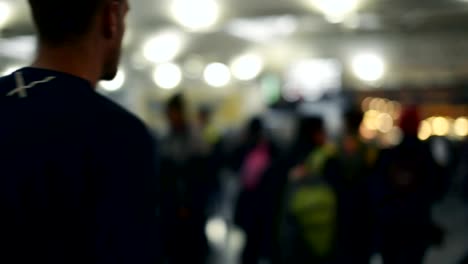 Defocused-traveler-and-crowded-people-walking-in-the-airport.