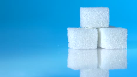 Table-top-shot-Group-of-Sugar-cubes-vary-position-on-light-blue-background