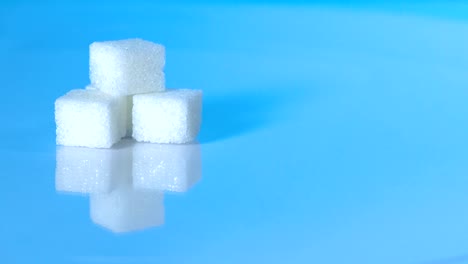 Table-top-shot-Group-of-Sugar-cubes-vary-position-on-light-blue-background