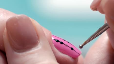 Extreme-Close-up,-Manicure-Master-Decorates-Girl's-Nail,-Puts-on-Pink-Lacquer-Brilliant-Dots