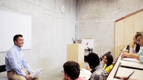 group-of-students-with-notebooks-in-lecture-hall