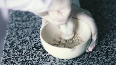 Laboratory-assistant-stirs-the-drug-in-a-plate