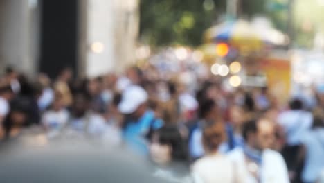 Crowd-of-people-walking-on-busy-city-street-out-of-focus