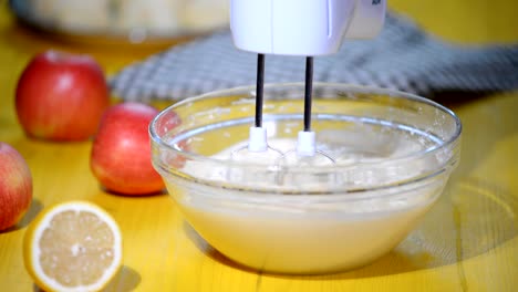 Electric-mixer-beats-mass-of-batter-in-the-kitchen.-Making-apple-cake