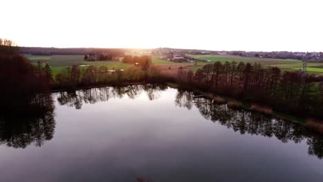 Aerial-flight-over-fishing-lake-in-fall