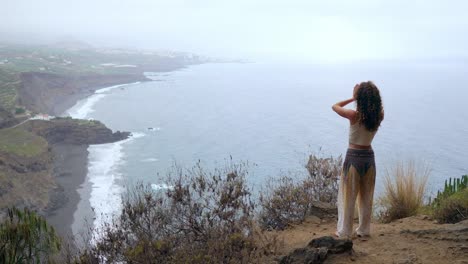 Young-woman-meditate-on-the-top-of-mountain