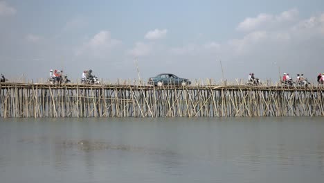 Stau-auf-der-Bambusbrücke-über-den-Mekong-Fluss;-Motorräder-und-Autos-überqueren-(Zeitraffer)