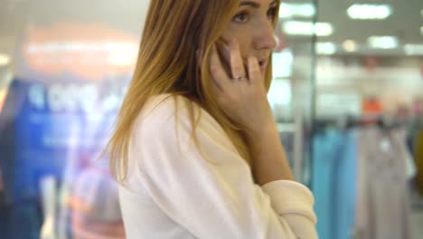 Beautiful-woman-talking-on-mobile-in-mall.