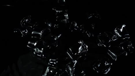 Falling-of-cubes-of-ice-on-a-black-background.-Slow-motion.