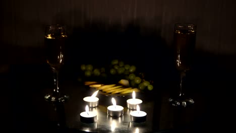 Romantic-evening-with-candles-with-champagne-and-fruits