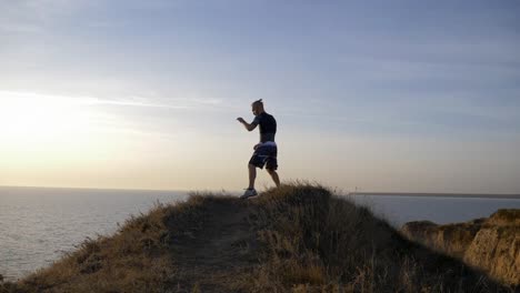 box-practicing,-healthy-wrestler-guy-perform-fist-fight-before-contest-on-hill-near-water