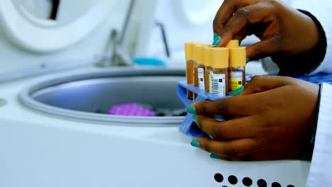 Laboratory-technician-taking-out-blood-plasma-samples-from-centrifuge-4k