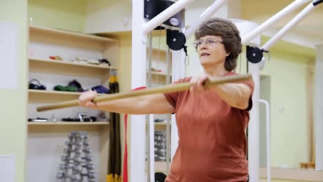 Senior-woman-doing-exercises-in-fitness-room.