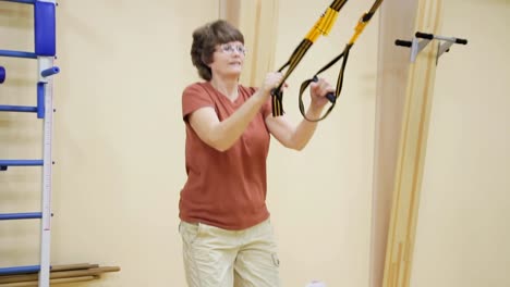 Senior-woman-doing-exercises-in-fitness-room.