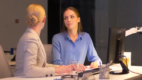 businesswomen-with-computer-working-late-at-office