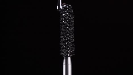 drops-of-black-mascara-fall-on-the-brush-on-a-black-background-2