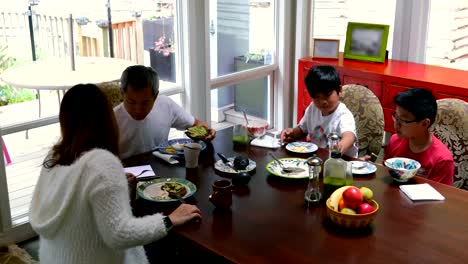 Family-members-having-breakfast-on-dining-table-4k