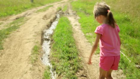 Little-girl-walking-along-a-rural-road