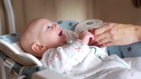 Baby-Lying-in-the-Baby-Rocking-Chair-and-Smiling