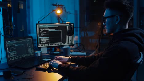 asian-hacker-in-dark-room-with-computers-at-night