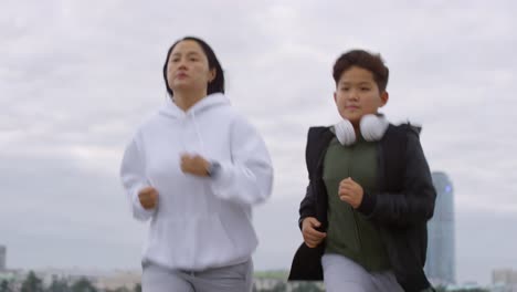 Asian-Mother-and-Son-Running-in-the-City