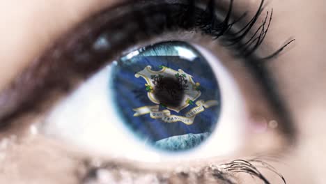 Woman-blue-eye-in-close-up-with-the-flag-of-Connecticut-state-in-iris,-united-states-of-america-with-wind-motion.-video-concept