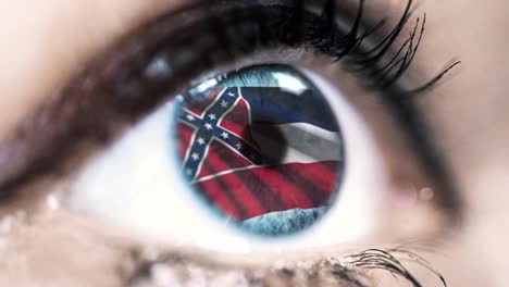 Woman-blue-eye-in-close-up-with-the-flag-of-Mississippi-state-in-iris,-united-states-of-america-with-wind-motion.-video-concept