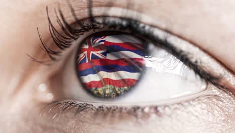 Woman-green-eye-in-close-up-with-the-flag-of-Hawaï-state-in-iris,-united-states-of-america-with-wind-motion.-video-concept