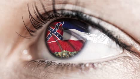 Woman-green-eye-in-close-up-with-the-flag-of-Mississippi-state-in-iris,-united-states-of-america-with-wind-motion.-video-concept