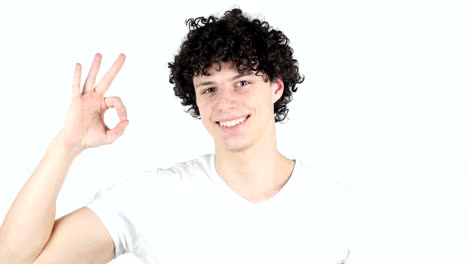 Okay-Sign-by-Young-Man-with-Curly-Hairs,-white-Background