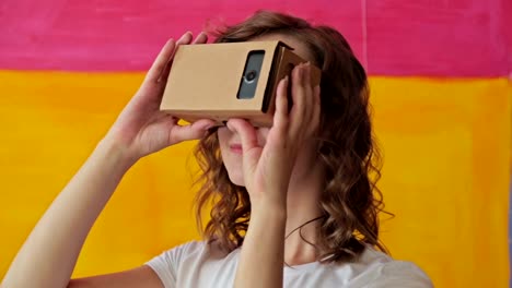 Young-curly-woman-using-Virtual-Reality-Glasses