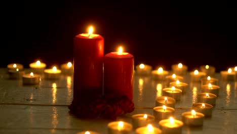 Candles-burning-lights-on-white-wood-table