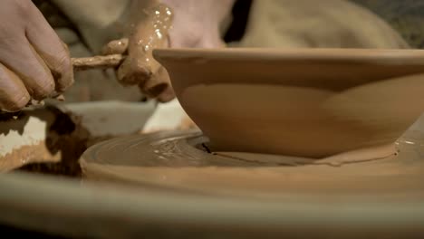 Male-potters-hands-making-a-bowl-on-a-wheel.