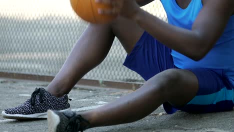 Male-warming-up-with-basket-ball,-waiting-for-team-players,-outdoor-activities