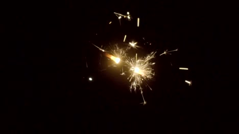 Firework-sparkler-burning-on-black-background-in-slow-motion