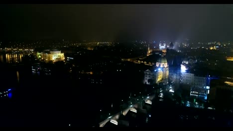 Night-panorama-of-Prague,-panoramic-view-from-the-air-to-the-old-town-and-Charles-Bridge,-lights-of-the-night-city,-Prague