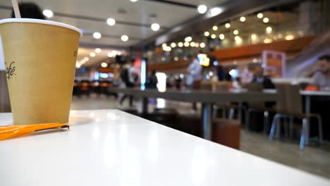 Blurred-unrecognizable-people-walking-in-terminal.-Unrecognizable-passengers-going-in-waiting-hall.-Defocus-background-from-busy-big-airport-with-people-stepping-for-the-flight.-Low-angle-view