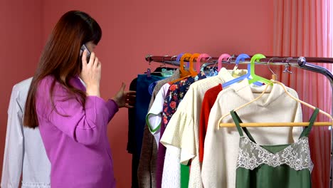 A-woman-looks-at-clothes-in-a-clothing-studio.